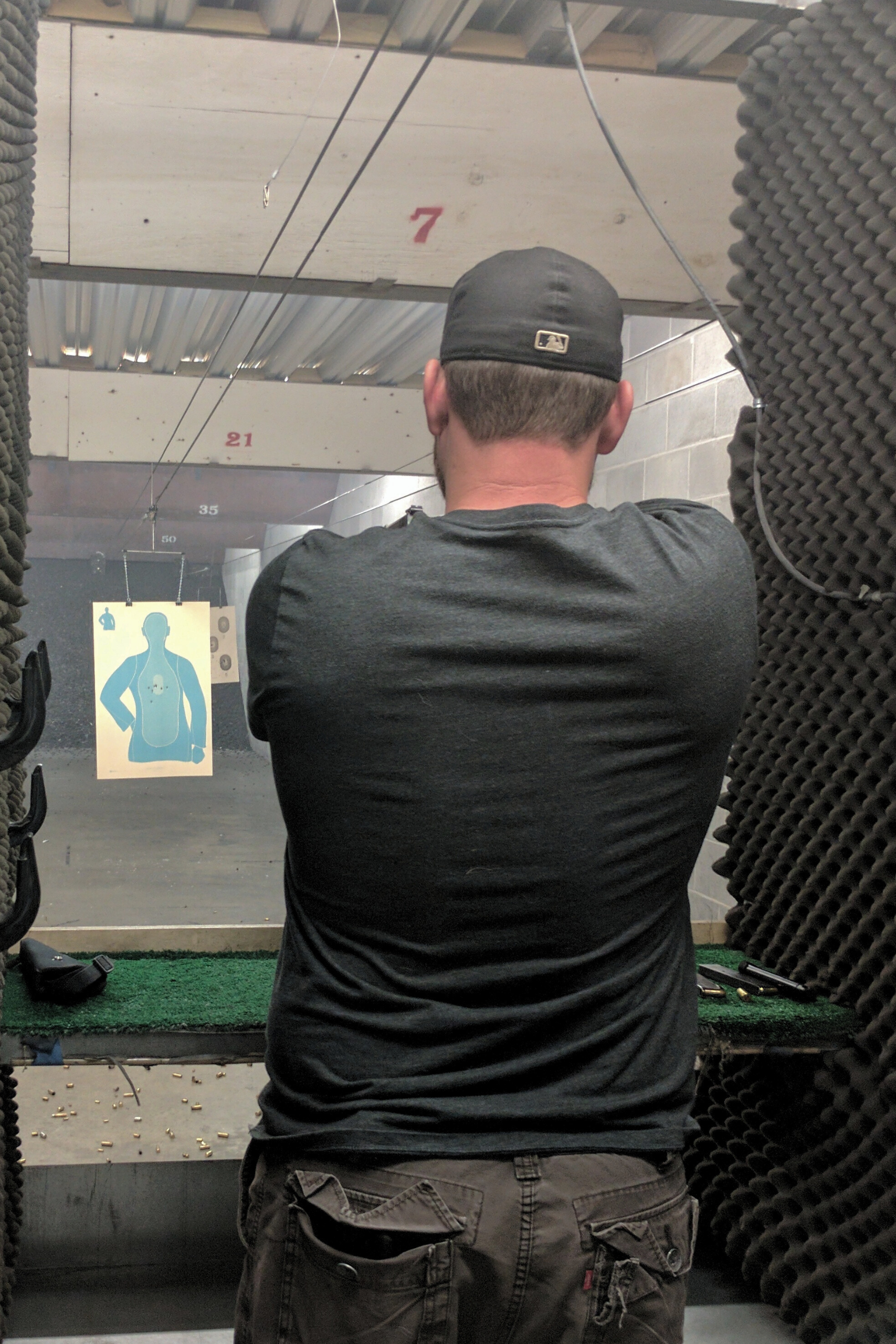 A man practicing in the indoor gun range.